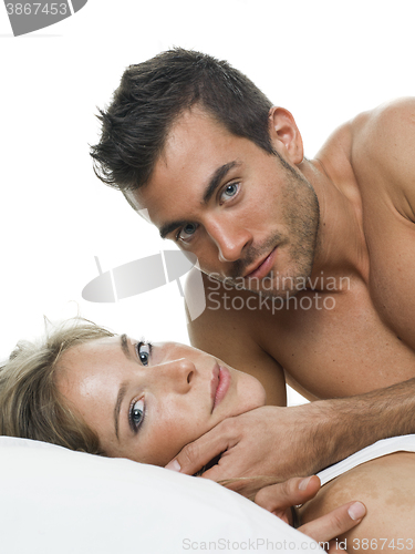 Image of attractive couple in love under white bed sheets