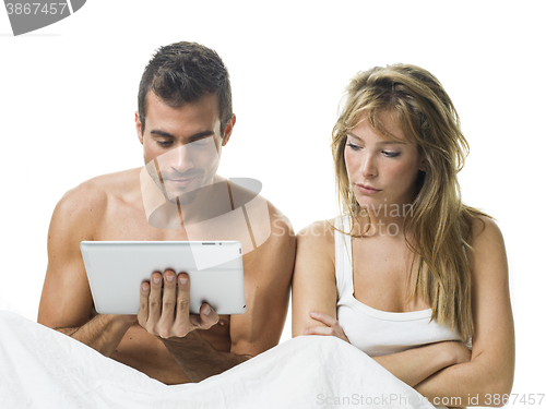 Image of uncommunicative couple on bed in white 