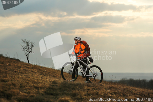 Image of Man cyclist with backpack riding the bicycle