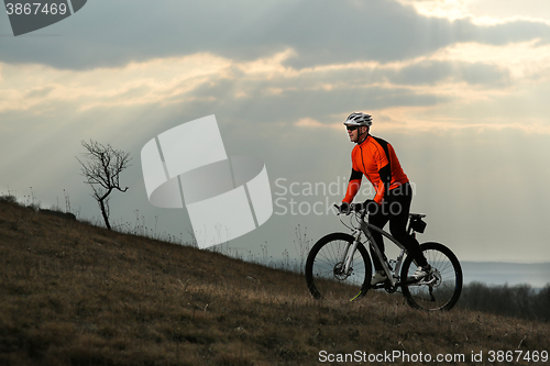 Image of Man cyclist with backpack riding the bicycle