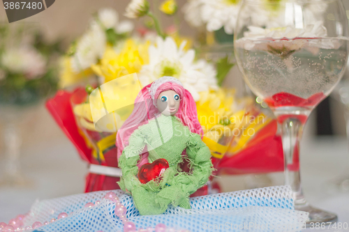 Image of Spring doll with red heart in hands