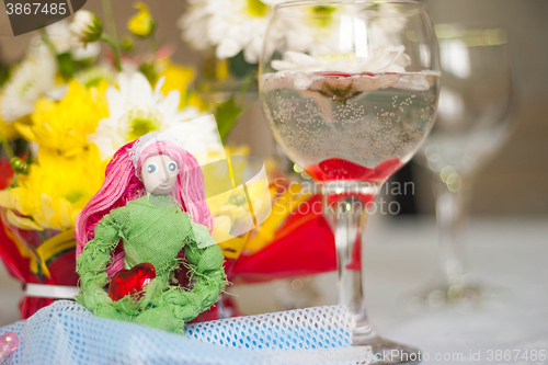Image of Spring doll with red heart in hands
