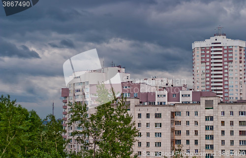 Image of Cityscape in the background of dark cloudy sky