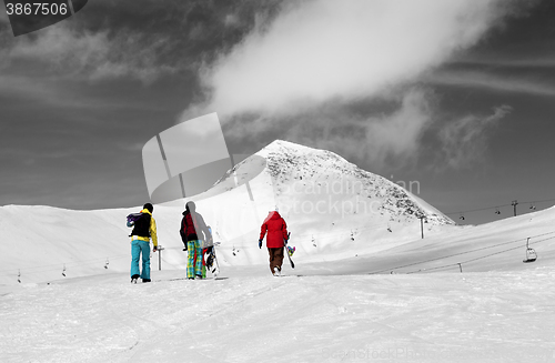 Image of Three snowboarder on slope. Selective color.