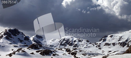 Image of Panoramic view on snowy mountains in clouds