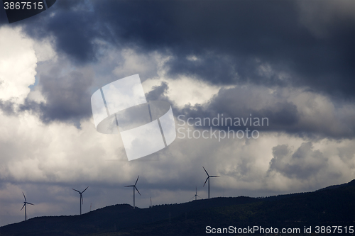 Image of Wind farm and cloudy sky before storm