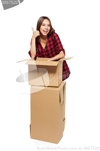 Image of Young woman with cardboard boxes