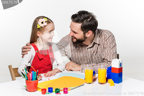 Image of The daughter and father drawing together