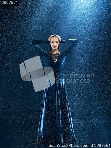 Image of The young beautiful modern dancer dancing under water drops