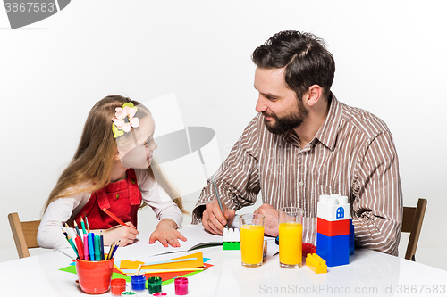Image of The daughter and father drawing together