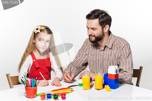 Image of The daughter and father drawing together