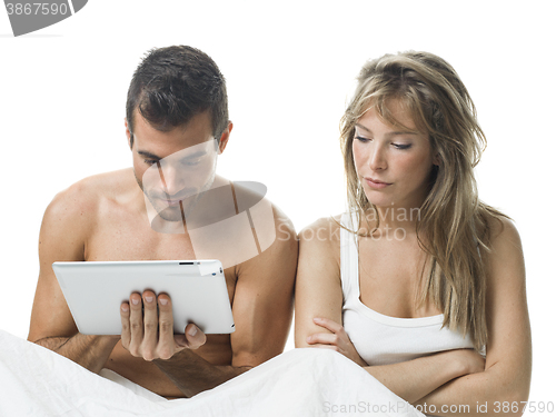 Image of uncommunicative couple on bed in white 