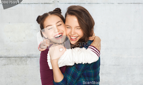 Image of happy smiling pretty teenage girls hugging