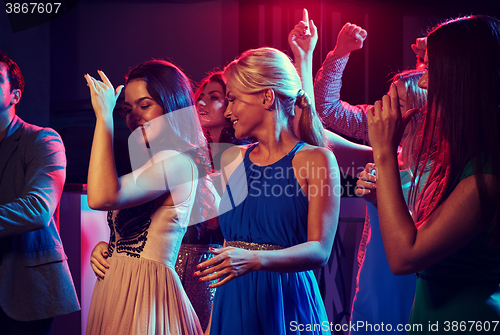 Image of group of happy friends dancing in night club