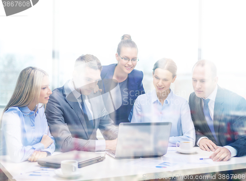 Image of business team with laptop having discussion