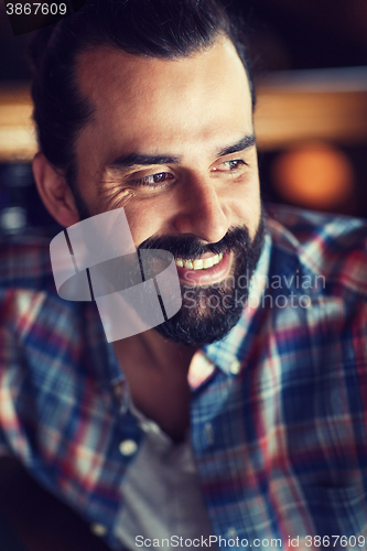 Image of happy young man with beard and mustache