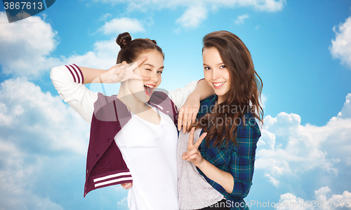 Image of happy pretty teenage girls showing peace hand sign