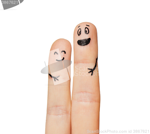 Image of close up of two fingers with smiley faces