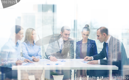 Image of business team with documents having discussion