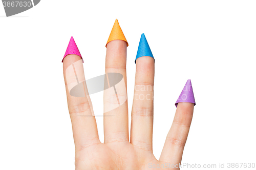 Image of close up of hand with four fingers in party hats