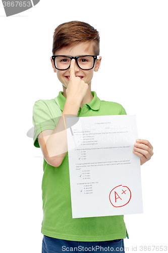 Image of happy boy in eyeglasses holding school test result