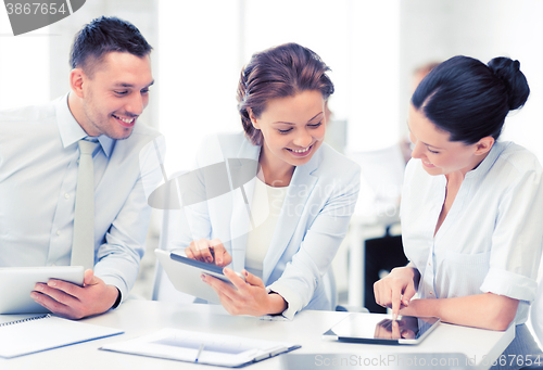 Image of business team working with tablet pcs in office