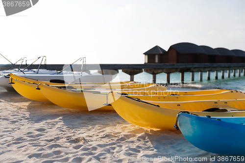 Image of canoes or kayaks mooring on sandy beach