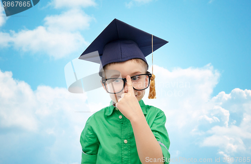 Image of happy boy in bachelor hat and eyeglasses