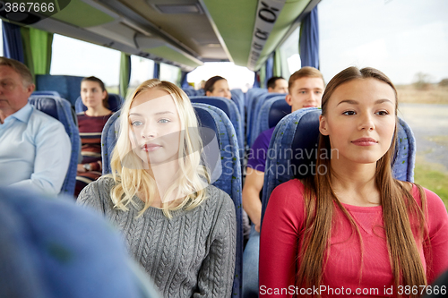 Image of happy young women riding in travel bus