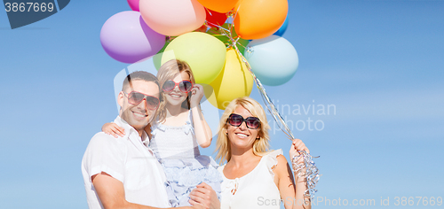 Image of family with colorful balloons