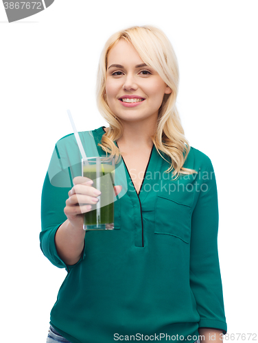 Image of smiling woman drinking vegetable juice or smoothie