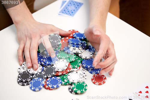 Image of hands with casino chips making bet or taking win