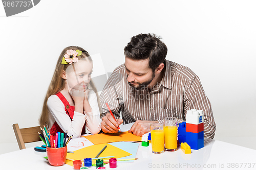 Image of The daughter and father drawing together