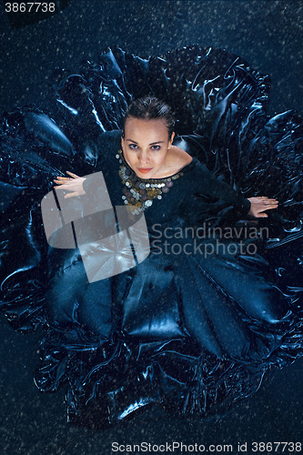 Image of The young beautiful modern dancer dancing under water drops