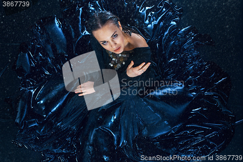 Image of The young beautiful modern dancer posing under water drops