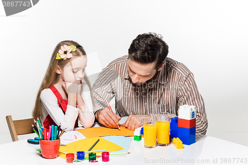 Image of The daughter and father drawing together