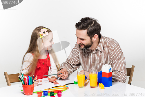 Image of The daughter and father drawing together