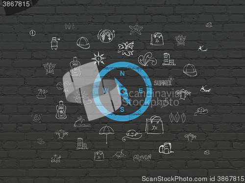 Image of Vacation concept: Compass on wall background