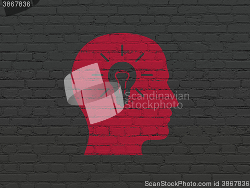Image of Advertising concept: Head With Light Bulb on wall background