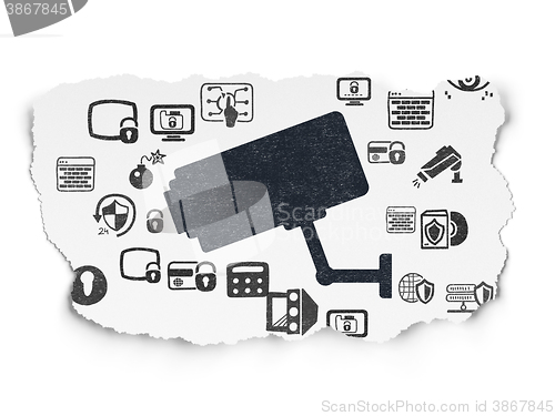 Image of Security concept: Cctv Camera on Torn Paper background