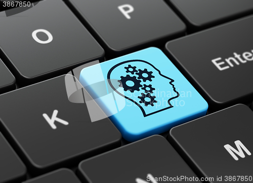 Image of Business concept: Head With Gears on computer keyboard background