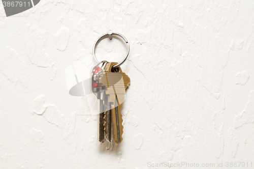 Image of keyring hanging on wall with keys