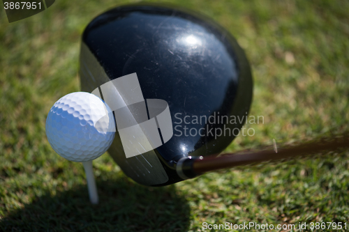 Image of top view of golf club and ball in grass