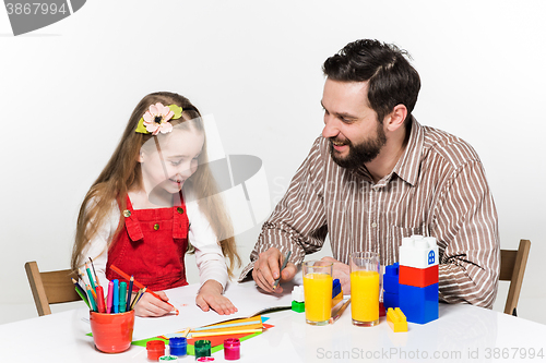 Image of The daughter and father drawing together