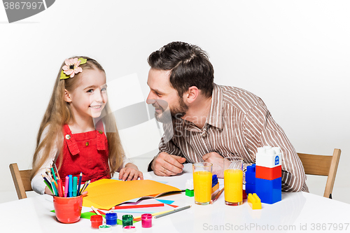 Image of The daughter and father drawing together