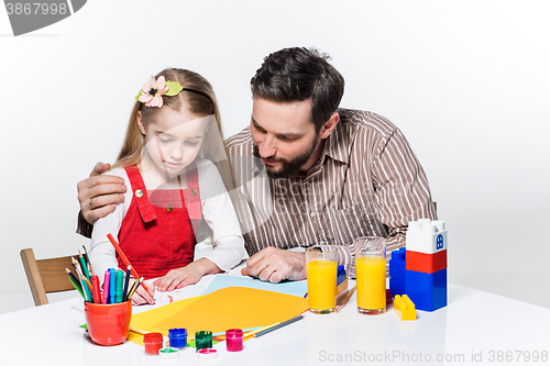 Image of The daughter and father drawing together