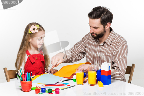 Image of The daughter and father drawing together