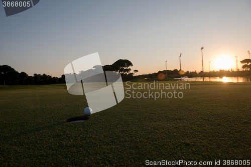 Image of golf ball on edge of  the hole