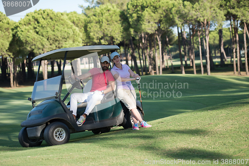 Image of couple in buggy on golf course