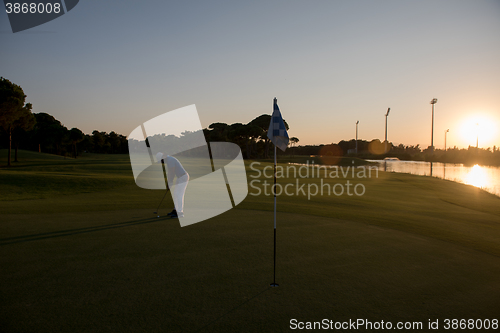 Image of golfer hitting ball to hole